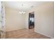 Dining room with neutral walls, chandelier, and view into the kitchen at 2332 Dovesong Trace Dr, Ruskin, FL 33570