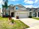 Charming two-story home with well-manicured lawn, large driveway, and a two car garage at 2332 Dovesong Trace Dr, Ruskin, FL 33570