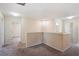 Hallway with neutral walls, carpeted floors, with multiple doorways, and white trim throughout at 2332 Dovesong Trace Dr, Ruskin, FL 33570