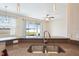 Bright kitchen featuring stainless steel sink, granite countertops, and a view to the backyard at 2332 Dovesong Trace Dr, Ruskin, FL 33570