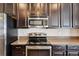 Kitchen featuring dark cabinets, stainless steel appliances, and granite countertops at 2332 Dovesong Trace Dr, Ruskin, FL 33570
