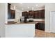 Open kitchen with dark cabinets, granite countertops, and stainless steel appliances at 2332 Dovesong Trace Dr, Ruskin, FL 33570