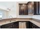 This kitchen features granite countertops, stainless steel appliances, and dark wood cabinetry at 2332 Dovesong Trace Dr, Ruskin, FL 33570