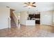 Open living space with view into the kitchen, ceramic tile floor, and staircase at 2332 Dovesong Trace Dr, Ruskin, FL 33570