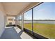 A covered patio overlooks a spacious backyard surrounded by a white fence providing privacy and ample outdoor space at 2332 Dovesong Trace Dr, Ruskin, FL 33570