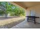 Covered back patio with outdoor grill and view of the spacious backyard at 2396 Malibu Ln, North Port, FL 34286