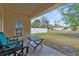 Covered back patio featuring outdoor seating and view of the fenced backyard at 2396 Malibu Ln, North Port, FL 34286