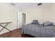 Bedroom featuring hardwood floors, neutral tones, and plenty of natural light at 2396 Malibu Ln, North Port, FL 34286