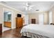 Large bedroom with hardwood floors, multiple windows, and a ceiling fan at 2396 Malibu Ln, North Port, FL 34286