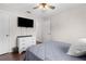 This bedroom features a ceiling fan, dresser, and TV for your comfort and entertainment at 2396 Malibu Ln, North Port, FL 34286
