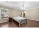 Spacious bedroom with hardwood floors, ceiling fan, and natural light at 2396 Malibu Ln, North Port, FL 34286