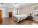 Well-lit bedroom featuring hardwood floors, ceiling fan, and a window at 2396 Malibu Ln, North Port, FL 34286