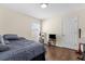 Cozy bedroom with a comfortable bed, hardwood floors, and bright window at 2396 Malibu Ln, North Port, FL 34286
