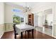 Bright dining room with large windows, wainscoting, and an open view to the entryway and living spaces at 2396 Malibu Ln, North Port, FL 34286