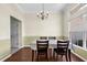 Elegant dining room featuring a chandelier, wainscoting, and a large window offering ample natural light at 2396 Malibu Ln, North Port, FL 34286