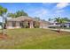 Beautiful single-story home with lush green lawn, well-maintained landscaping, and a boat on the driveway at 2396 Malibu Ln, North Port, FL 34286