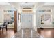 Bright foyer with ceramic tile, high ceilings, transom windows, and a view into the living spaces at 2396 Malibu Ln, North Port, FL 34286