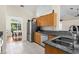 Bright kitchen with stainless steel appliances, double sink, and granite countertops at 2396 Malibu Ln, North Port, FL 34286
