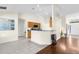 Spacious living room flows into kitchen with tiled floors and neutral paint at 2396 Malibu Ln, North Port, FL 34286