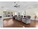 Spacious living room with hardwood floors, large windows, and modern ceiling fan at 2396 Malibu Ln, North Port, FL 34286