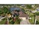 Stunning aerial view of home with solar panels, lush landscaping, and circular driveway at 24342 Saragossa Ln, Punta Gorda, FL 33955