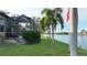 Scenic backyard featuring lush greenery and picturesque waterfront views, offering a serene outdoor space with a lake at 24342 Saragossa Ln, Punta Gorda, FL 33955