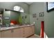 Bathroom featuring dual sinks with a granite countertop, and decorative wall art at 24342 Saragossa Ln, Punta Gorda, FL 33955