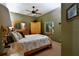 Bedroom featuring queen bed, window with blinds, ceiling fan, and side table at 24342 Saragossa Ln, Punta Gorda, FL 33955