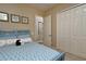 Bedroom featuring blue bed frame, starfish pillows, and large closet at 24342 Saragossa Ln, Punta Gorda, FL 33955