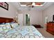Comfortable main bedroom with ensuite bathroom view; features a ceiling fan and natural light at 24342 Saragossa Ln, Punta Gorda, FL 33955