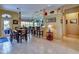 Bright dining area with wooden table set and bar seating; an open-concept design seamlessly connects to the kitchen at 24342 Saragossa Ln, Punta Gorda, FL 33955