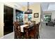 Inviting dining area with wood table set and sliding glass doors leading to an outdoor view at 24342 Saragossa Ln, Punta Gorda, FL 33955