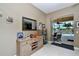 Inviting entryway featuring a console table, mirror, and view of the pool area at 24342 Saragossa Ln, Punta Gorda, FL 33955