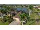 Beautiful waterfront home featuring a spacious lawn, mature palms, and solar panels for energy efficiency at 24342 Saragossa Ln, Punta Gorda, FL 33955