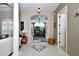 Grand foyer featuring tile flooring and an arched window, creating a bright and inviting entrance at 24342 Saragossa Ln, Punta Gorda, FL 33955