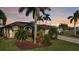 Charming home with a well-manicured lawn and tropical landscaping creating inviting curb appeal at 24342 Saragossa Ln, Punta Gorda, FL 33955