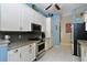 Bright kitchen featuring stainless steel appliances, granite countertops, and white cabinets at 24342 Saragossa Ln, Punta Gorda, FL 33955