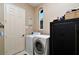Laundry room featuring washer and dryer, storage cabinet, and window at 24342 Saragossa Ln, Punta Gorda, FL 33955