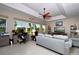 Bright living room features neutral furniture, a ceiling fan and a view of the outdoors at 24342 Saragossa Ln, Punta Gorda, FL 33955
