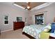 Comfortable main bedroom with ceiling fan, dresser with TV, and access to screened in porch at 24342 Saragossa Ln, Punta Gorda, FL 33955