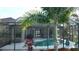 Inviting screened-in pool area surrounded by lush tropical landscaping at 24342 Saragossa Ln, Punta Gorda, FL 33955