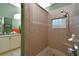 Tiled shower with built-in seat and decorative window, located in the bathroom at 24342 Saragossa Ln, Punta Gorda, FL 33955