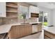 Modern kitchen with stainless steel appliances and stylish cabinets, complemented by a window offering outdoor views at 299 Australian Dr, Rotonda West, FL 33947