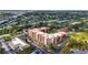 Aerial view of a condo complex with well-maintained landscaping and ample parking at 3006 Caring Way # 210, Port Charlotte, FL 33952