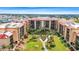 Aerial view of a complex surrounded by mature trees, lawns, and manicured landscaping at 3006 Caring Way # 210, Port Charlotte, FL 33952
