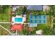 Aerial view featuring a community pool, pickleball courts, and beautiful landscaping at 3006 Caring Way # 210, Port Charlotte, FL 33952