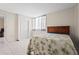 Comfortable bedroom with a bright window view, neutral wall color, and easy access to the exterior at 3006 Caring Way # 210, Port Charlotte, FL 33952