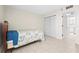Cozy bedroom with a closet, neutral wall color, and a view leading to the kitchen at 3006 Caring Way # 210, Port Charlotte, FL 33952