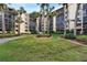 Exterior view of the lush, well-maintained grounds and landscaping surrounding the condo complex at 3006 Caring Way # 210, Port Charlotte, FL 33952