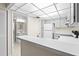 Bright kitchen features a breakfast bar, white cabinetry, and stainless steel appliances at 3006 Caring Way # 210, Port Charlotte, FL 33952